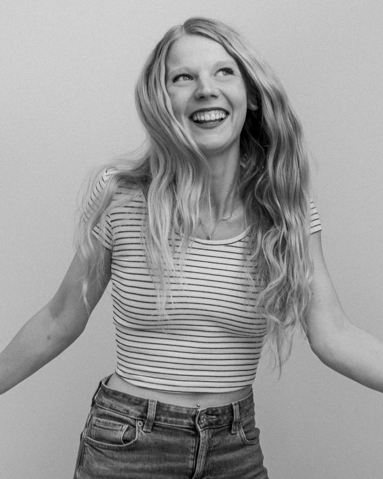 Kassandra laughing in a black-and-white portrait