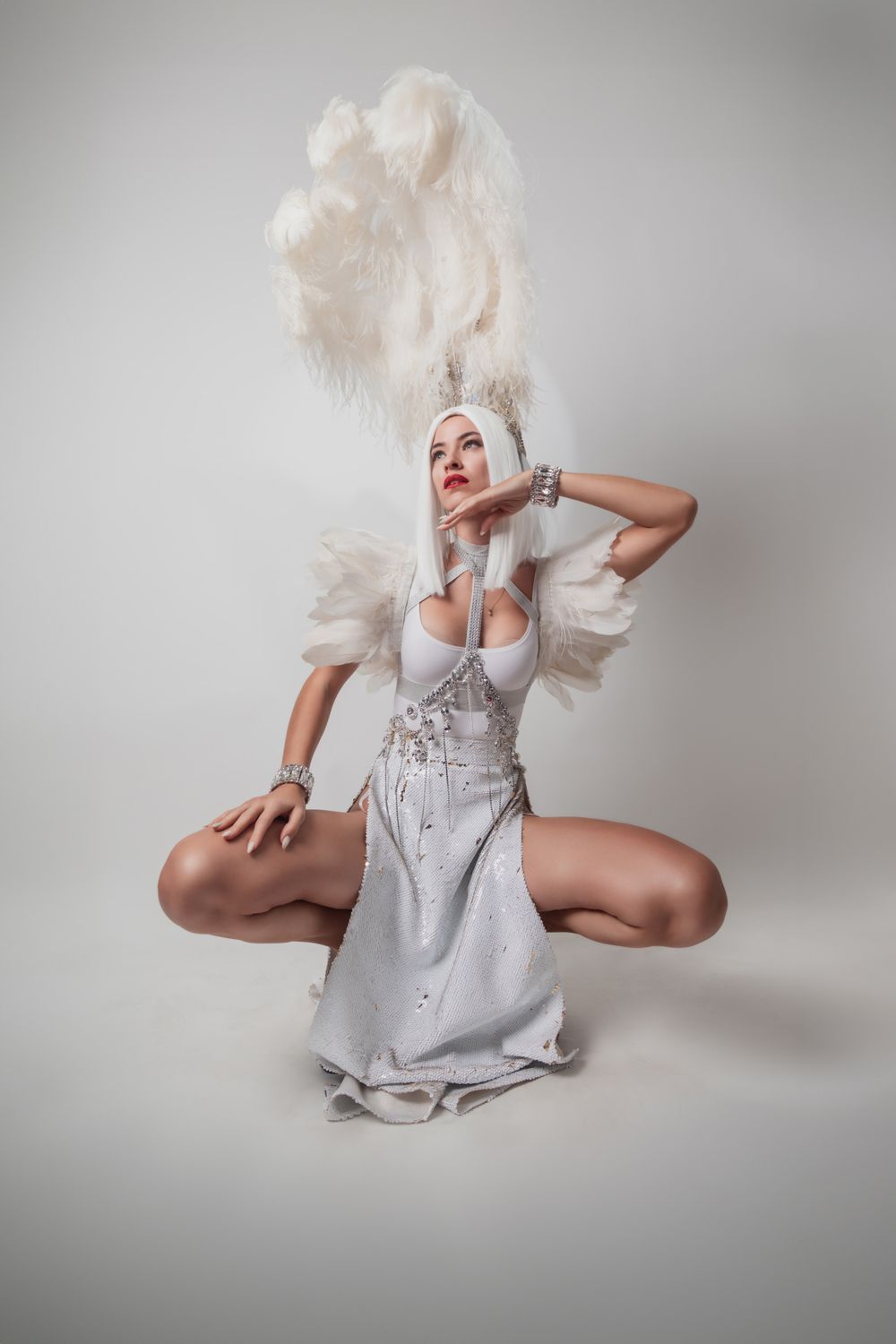 Saskia Lund in a white feather performance headdress