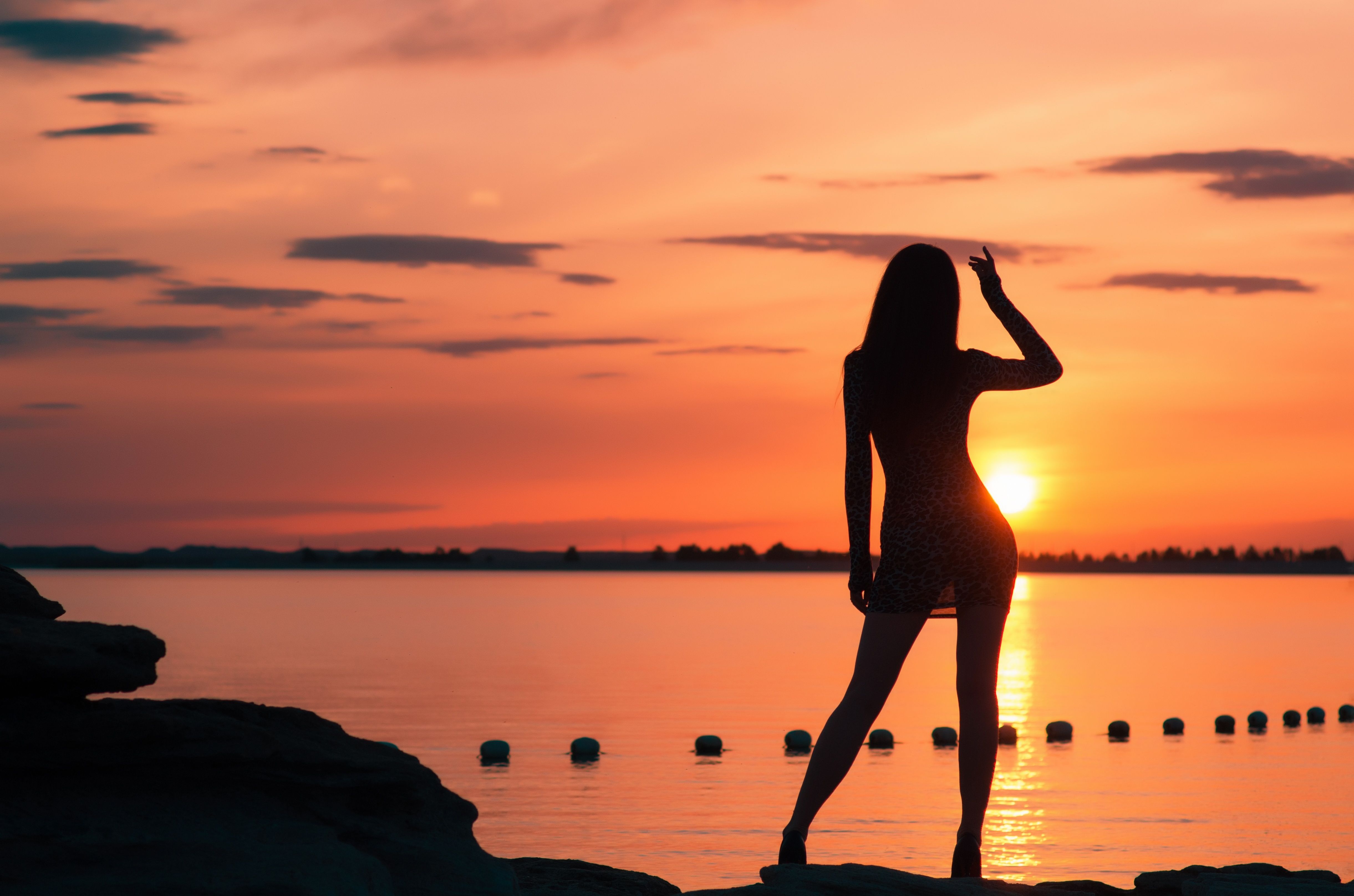 Woman silhouette in front of a sunset.